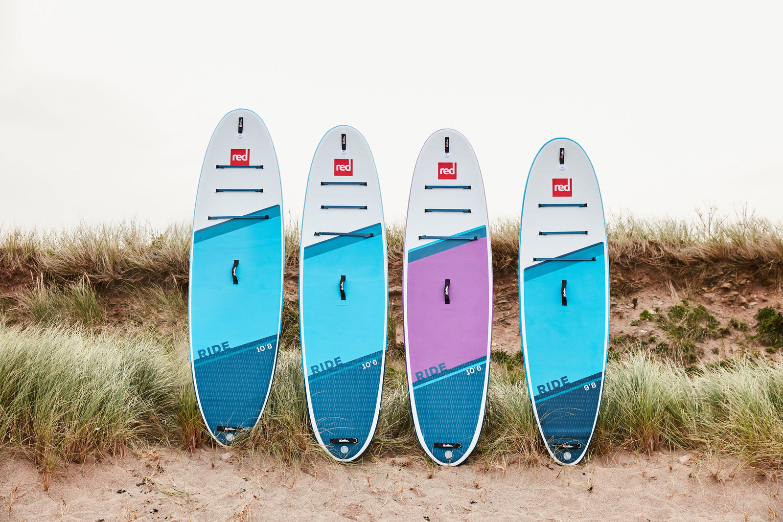 red paddleboards lined up 