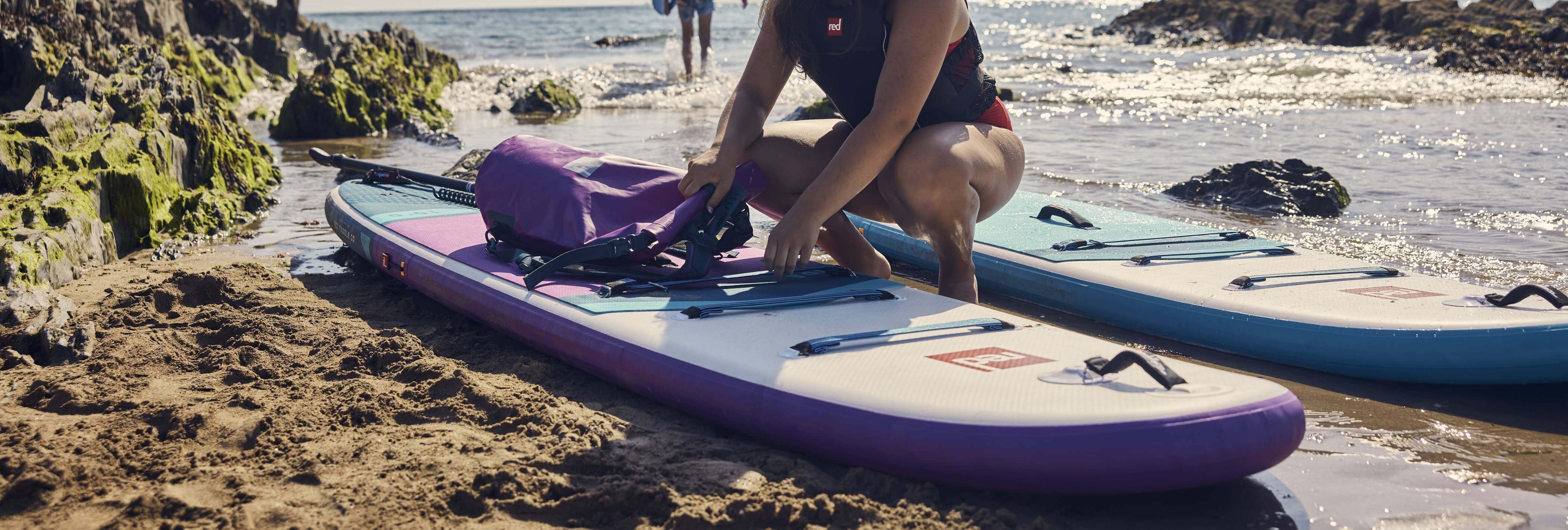 woman clipping back onto inflatable paddleboard