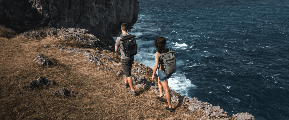 man and woman hiking with waterproof backpack