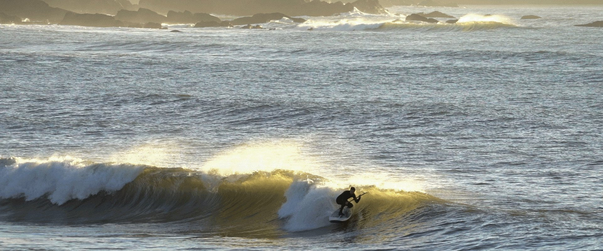 Paddle Boarder Surfing On A Compact Surf SUP