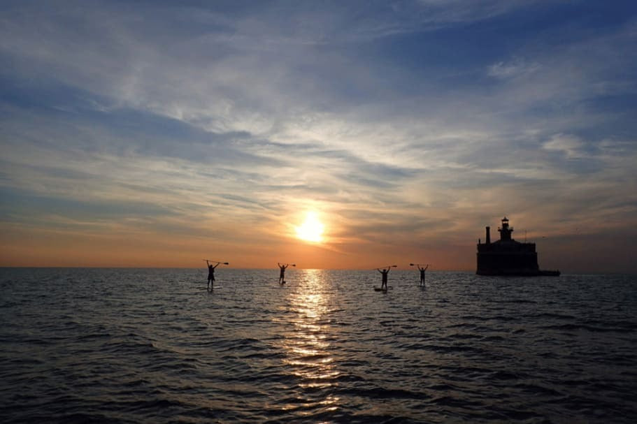 4 paddle boarders on Lake Michigan 