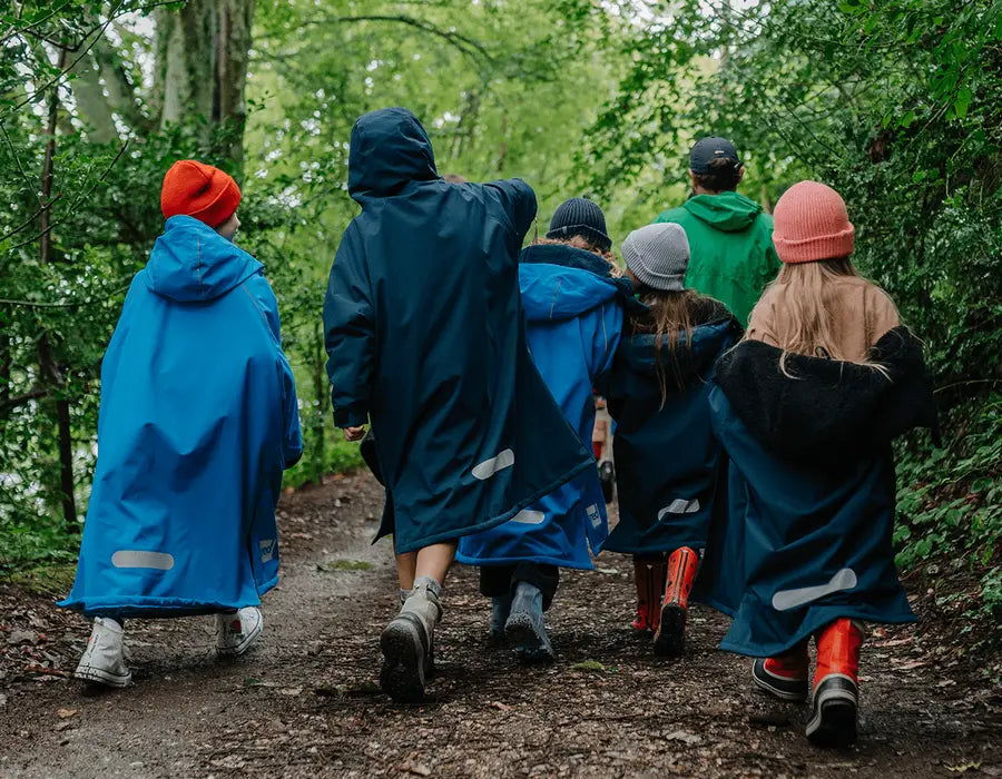 A group of children walking in the forest in their Red Pro Change Robes
