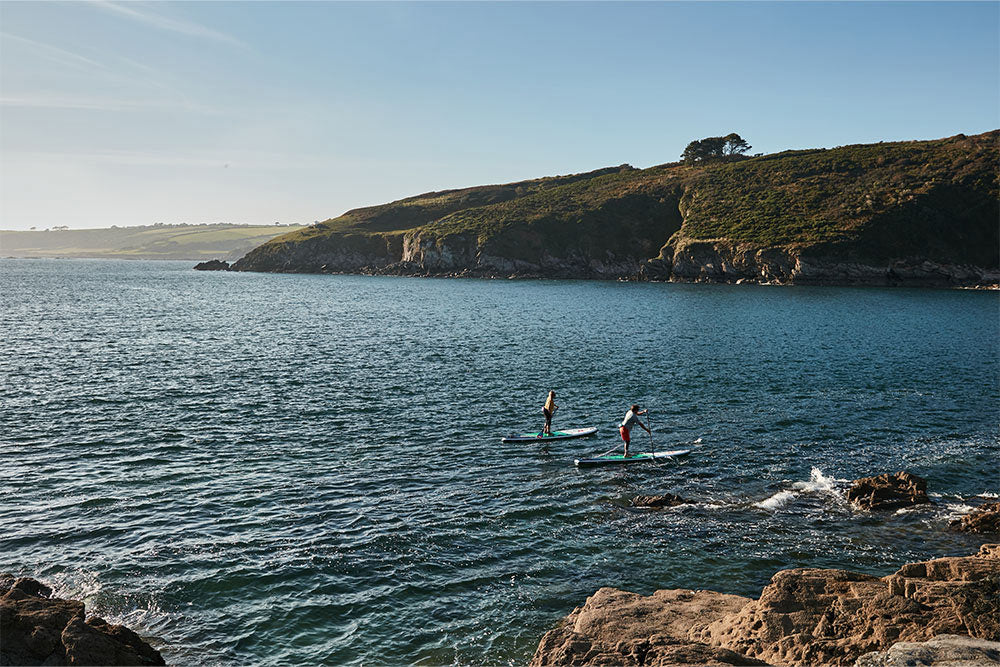 Man and woman paddle boarding in the sea