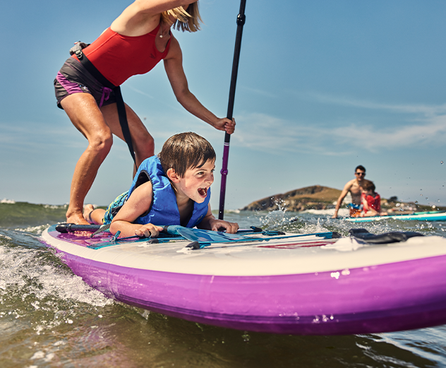 Family paddleboarding in the sea