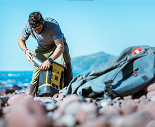 Man hiking using mustard waterproof cool bag backpack