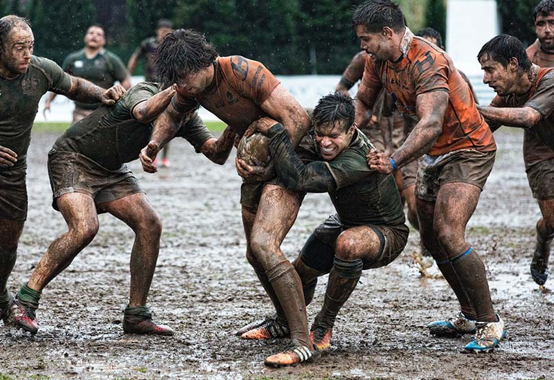 men playing rugby in mud