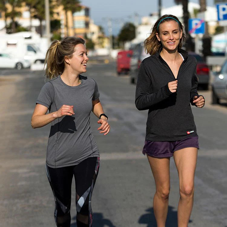 Two women running wearing Red Original performance t-shirt