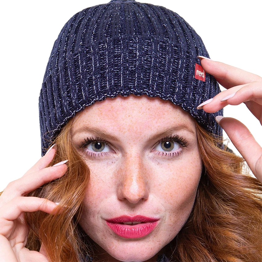 A woman wearing the navy merino beanie looking into the camera