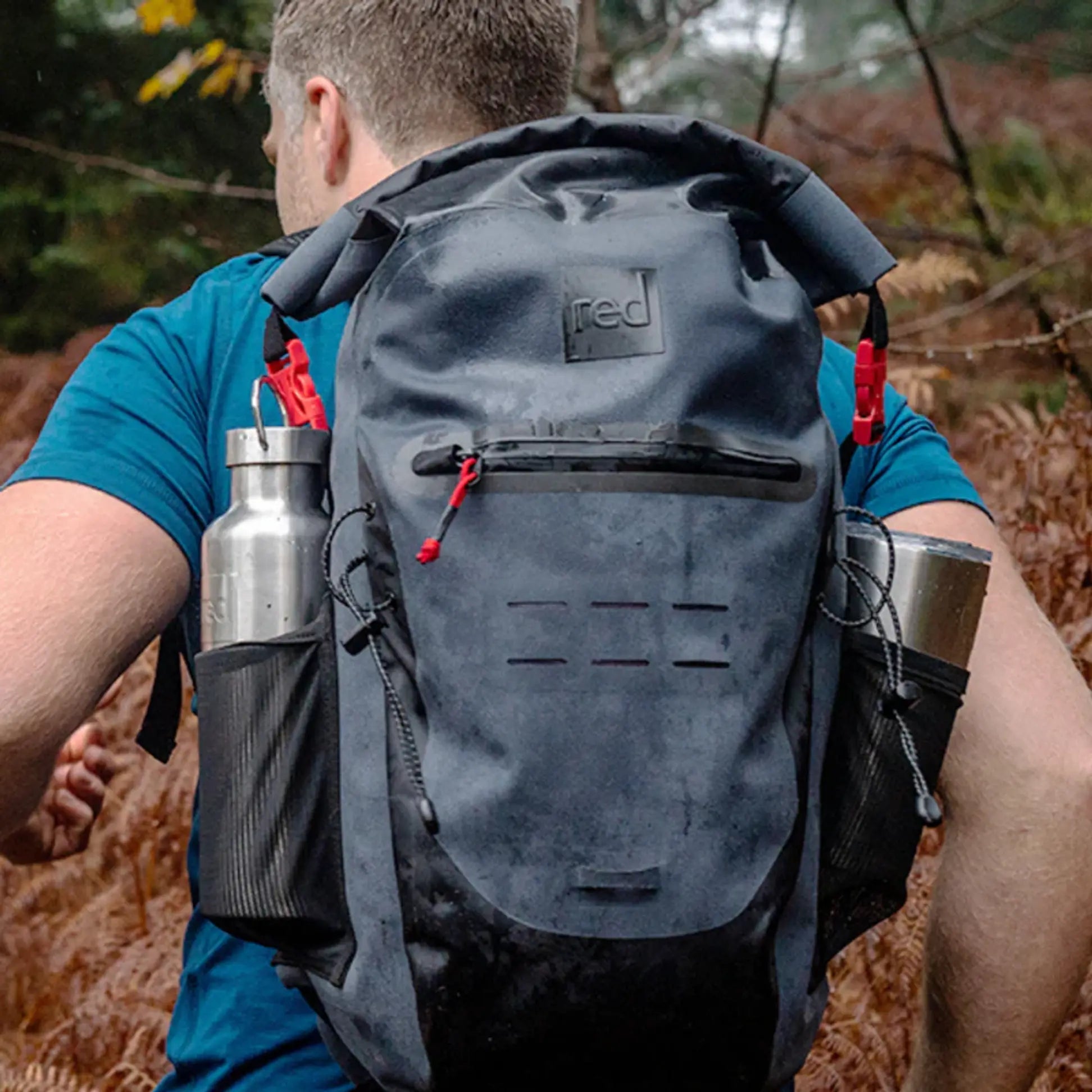 A person carrying the red backpack