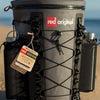 Red Paddle Co Waterproof SUP Deck Bag with 2 Insulated water bottles in external pockets on a beach